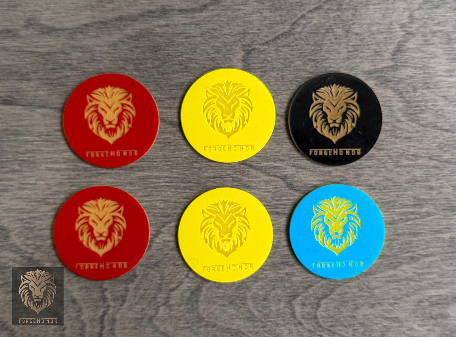 Colorful Forge Honor Age of Sigmar objective markers photographed on a wood tabletop