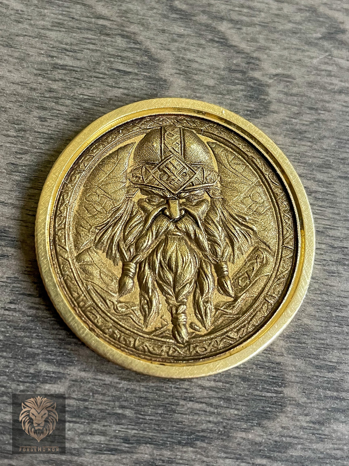 Custom brass fantasy coin photographed on a wood tabletop by Forge Honor